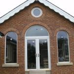 Ballynahich Rd,Dromore White french doors with arched fanlight, fixed arch windows and bullyeye window.